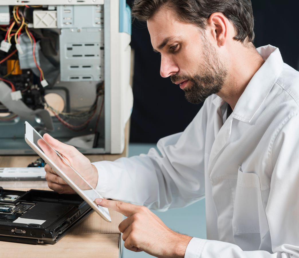 a maintenance engineer tapping on their tablet